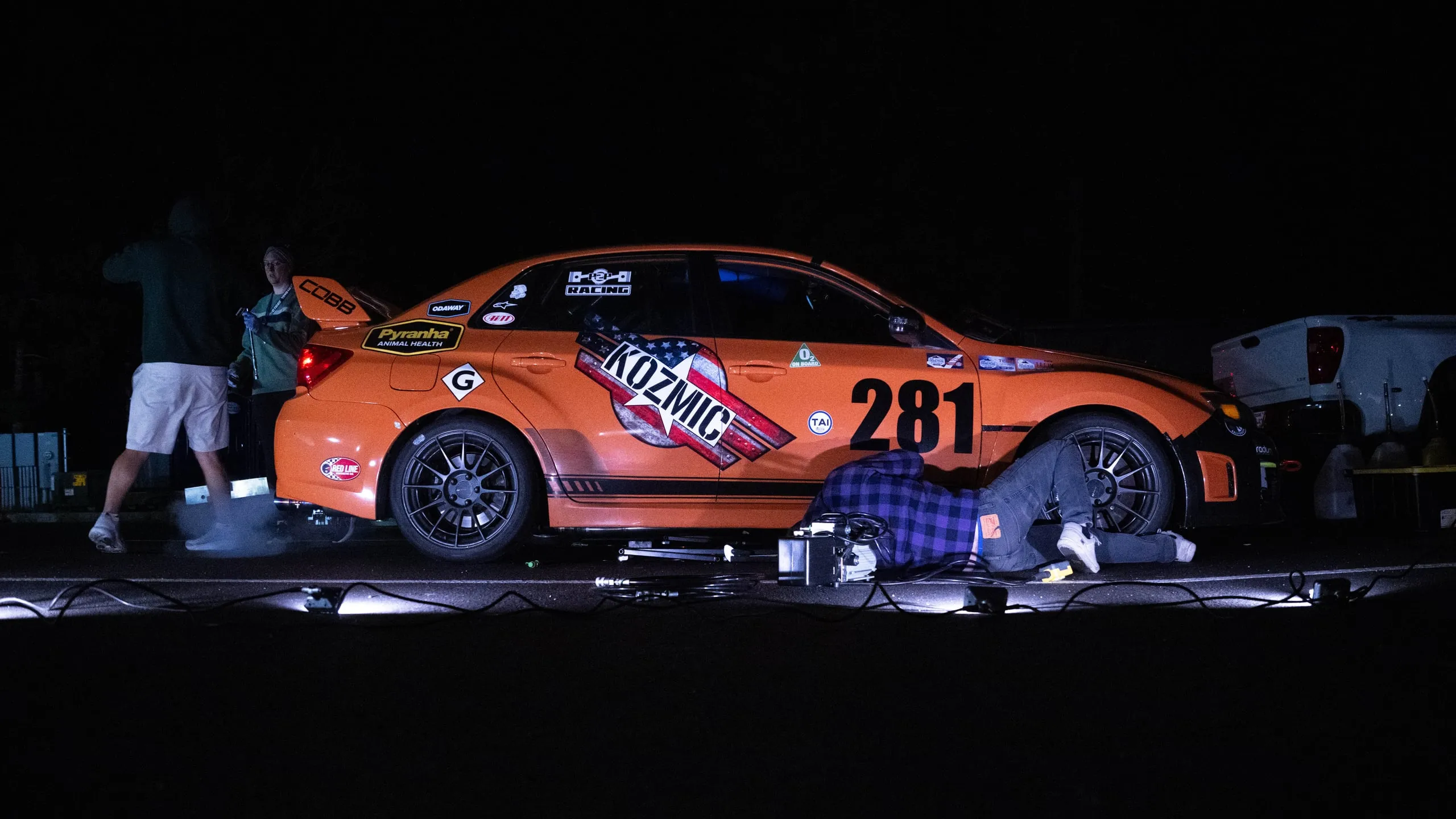 Sober Racing #281 under work lights at night during tech and prep