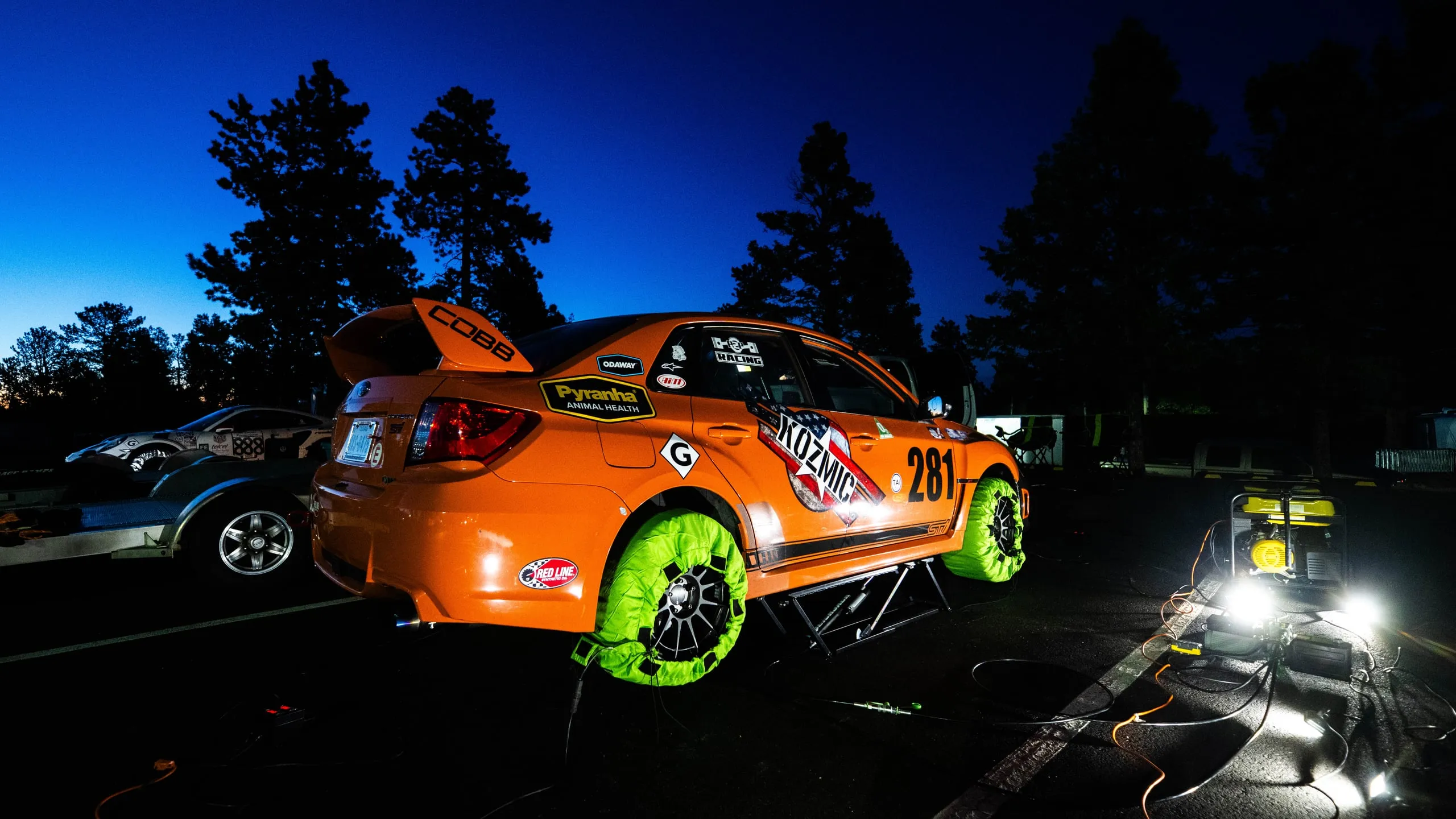 The #281 car lit up in the paddock the night before running