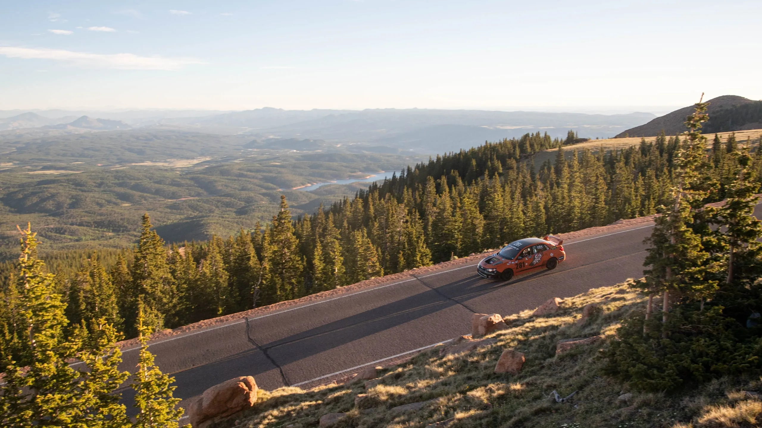 The #281 on the mountain road at golden hour, the valley falling away below